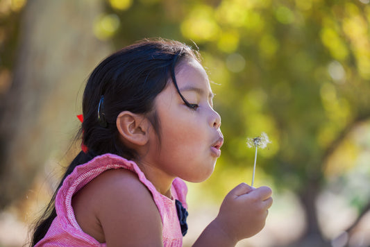 Toddler Girl blowing on flower - Breathing exercises cards for Toddlers